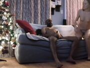 Interracial couple fucks on the couch by the Christmas tree
